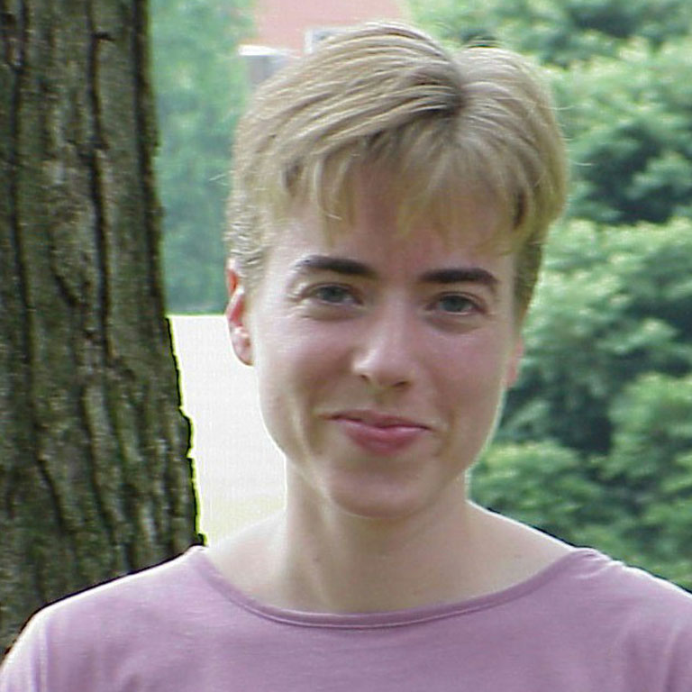 Portrait of Deborah Marr smiling at the camera.