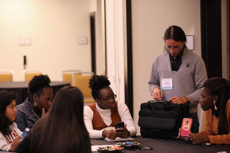 Salvador Rodriguez Valle is working with students at 2019 LSMRCE conference.